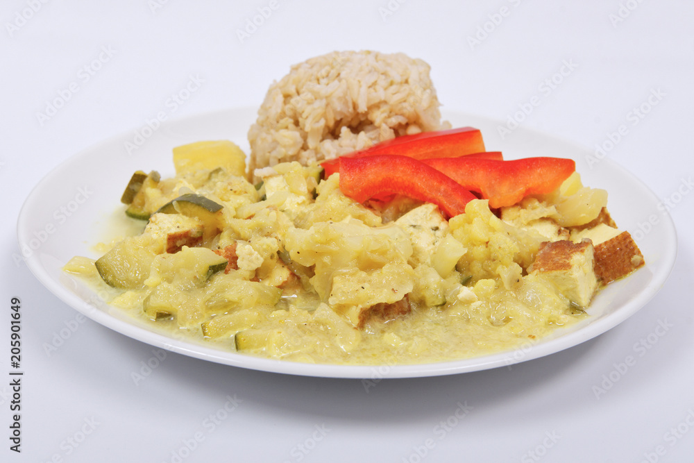 Cauliflower mixture with curry and rice on a white Cauliflower mixture with curry and rice on a white