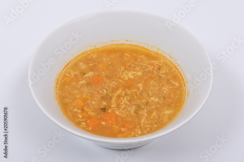 Groat soup with vegetables on a white