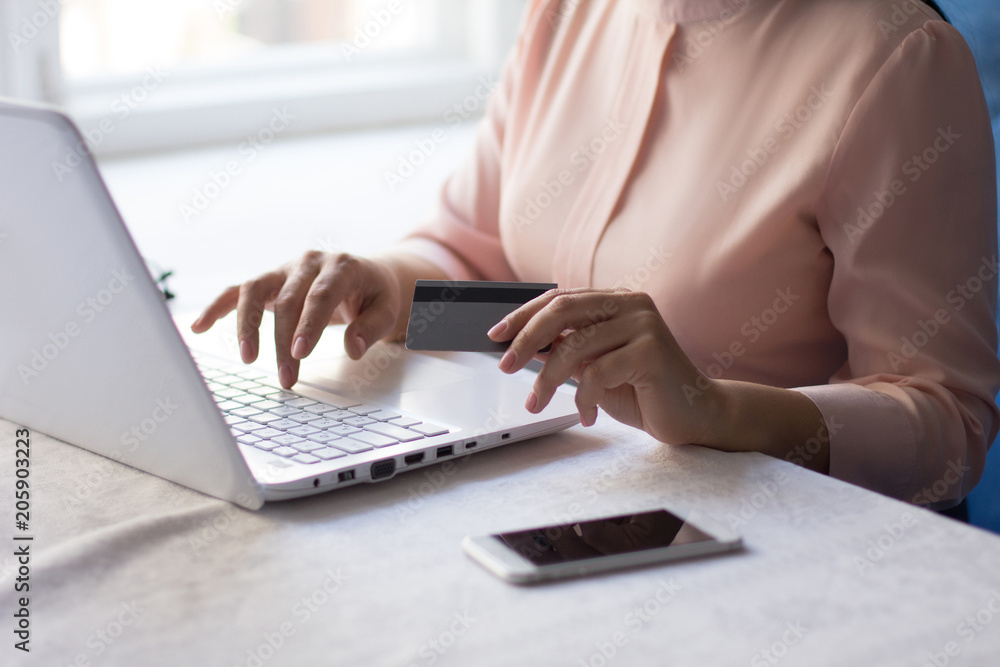 Fototapeta premium Shot of a beautiful young businesswoman using laptop. Typing message to partner.