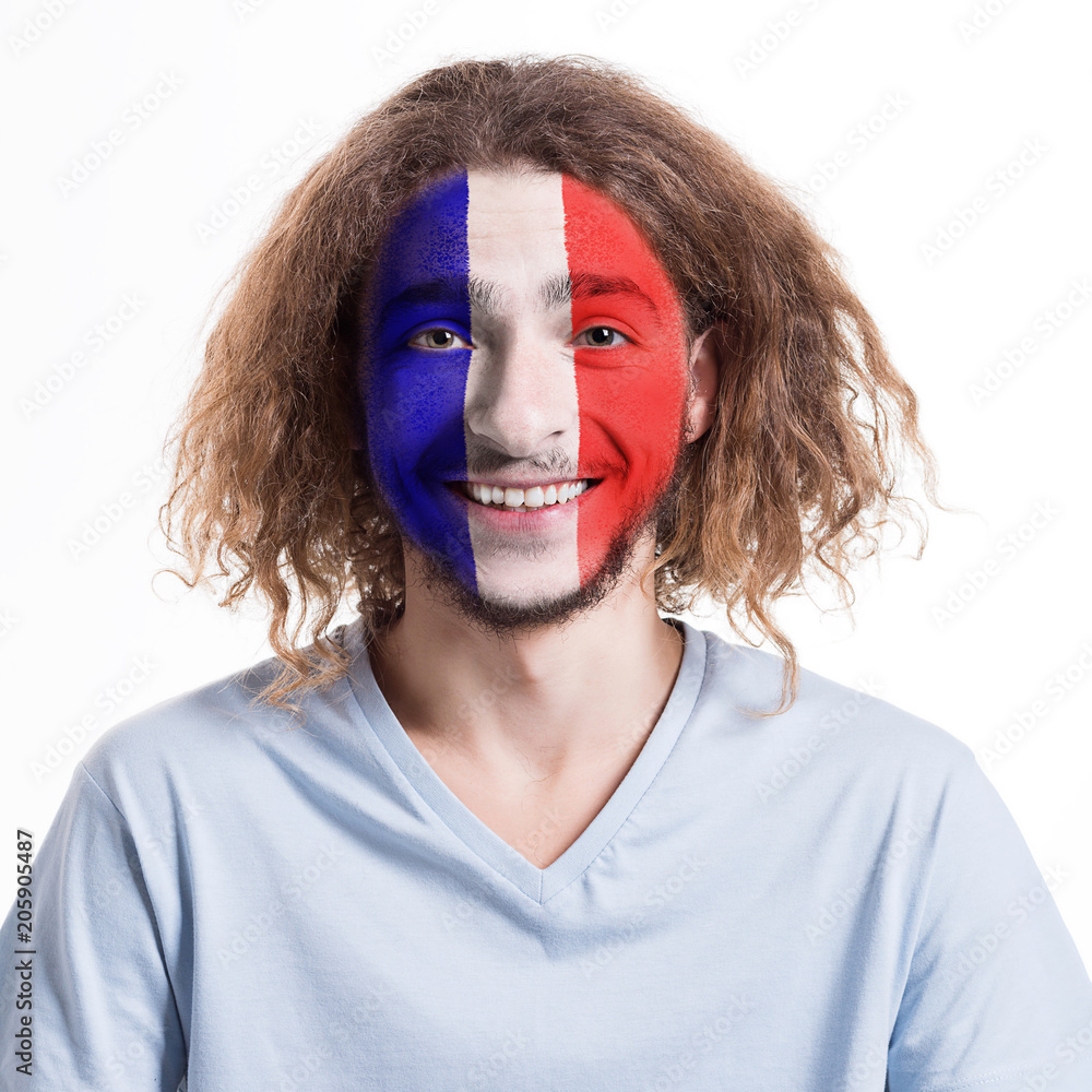 Young man with France flag painted on his face