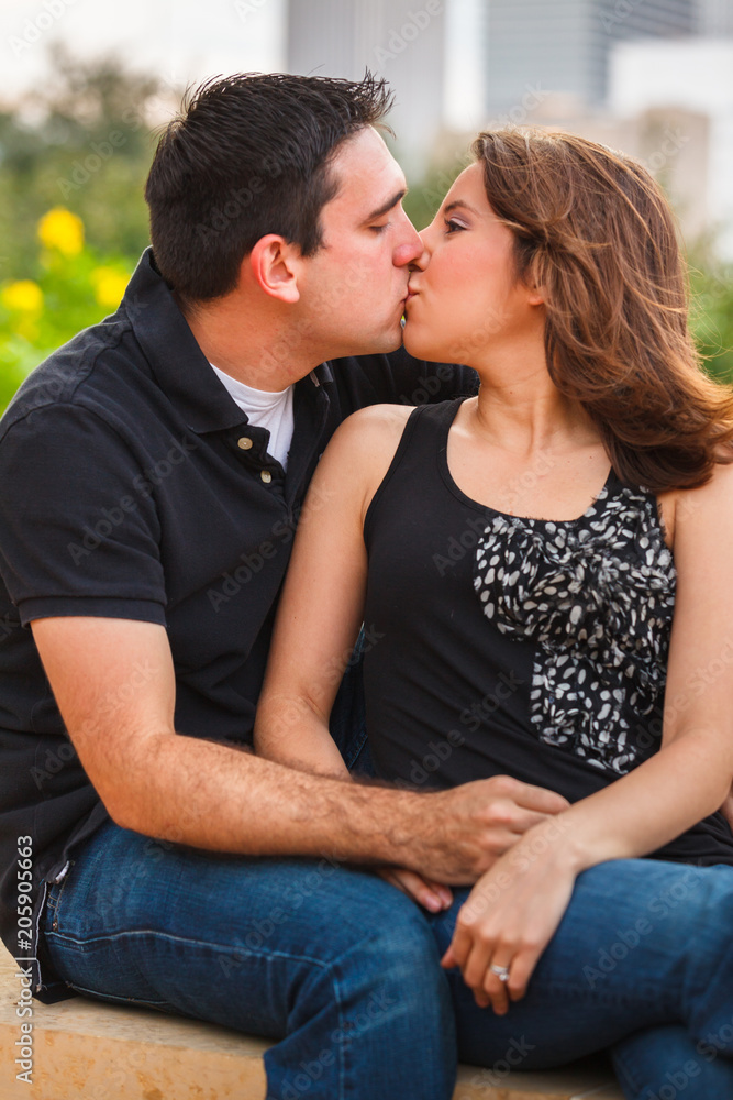 Young couple outdoor portrait in a downtown urban park Young couple outdoor portrait in a downtown urban park