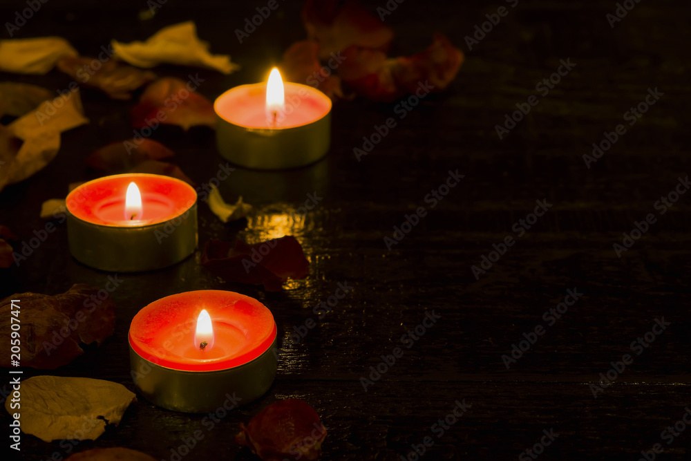 Lighted candle on the background of a large number of wilted leaves Lighted candle on the background of a large number of wilted leaves