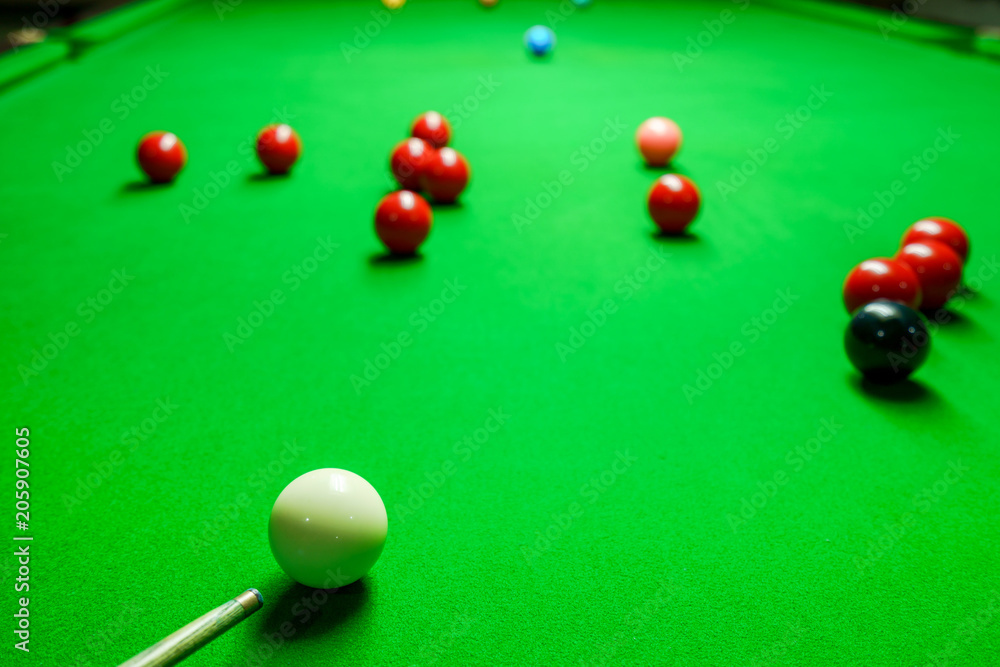 Player was shooting ball on green snooker table Player was shooting ball on green snooker table