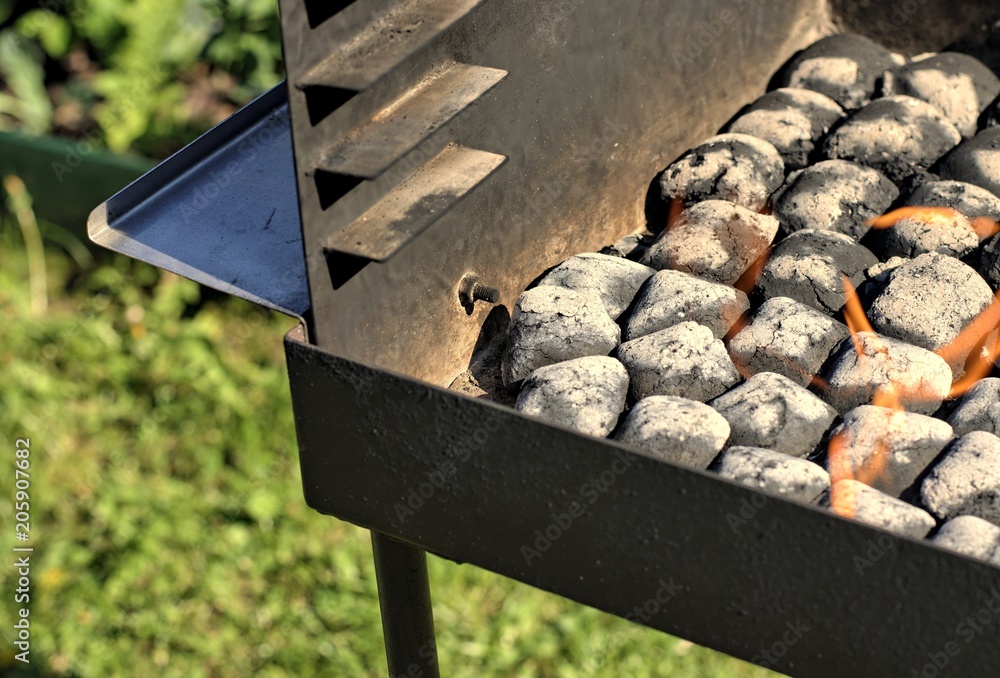 Outdoors and barbecue concept fire when lighting charcoal briquettes