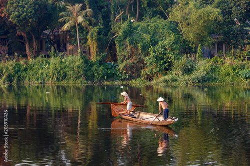 Vietnamese fishermen in famous Perfume River in Hue City, Vietnam