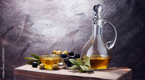 Fototapeta Naklejka Na Ścianę i Meble -  Bottle virgin olive oil and oil in a bowl with some olives