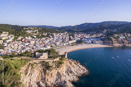Aerial view of picturesque rocky landscape with fortified walls and residential buildings of Tossa de Mar, Spain