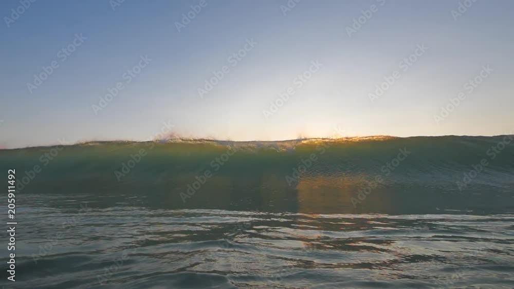 Slow motion shot of sunset surfing wave in Indonesia at Bali island Slow motion shot of sunset surfing wave in Indonesia at Bali island