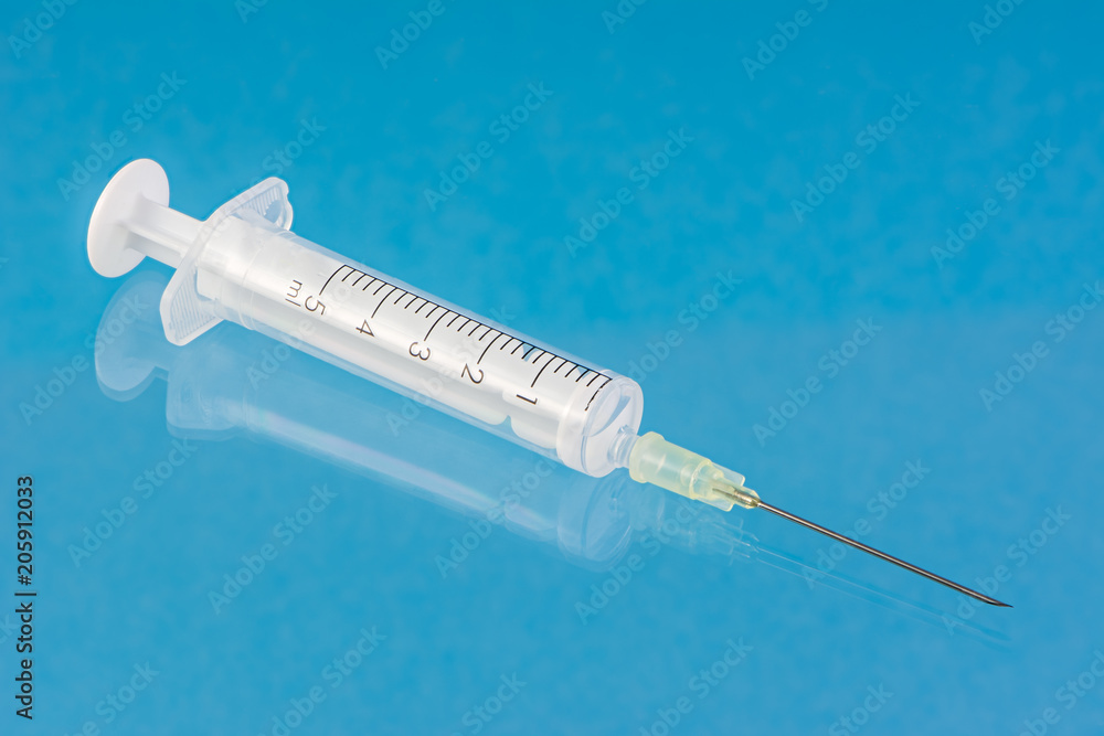 White syringe with a needle White syringe with a needle