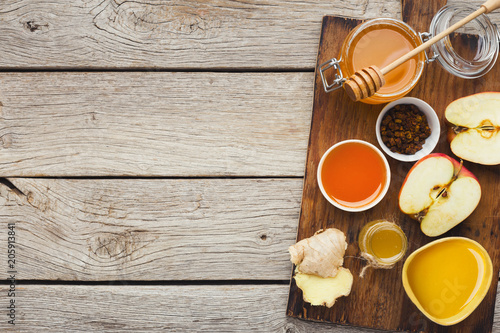 Various types of honey on wooden background, top view