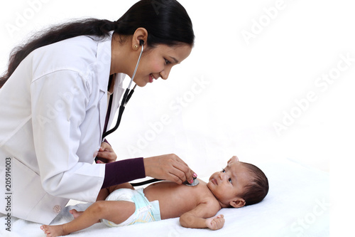 Newborn baby examination by doctor woman