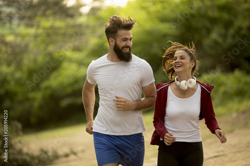 Couple jogging outdoors in ...