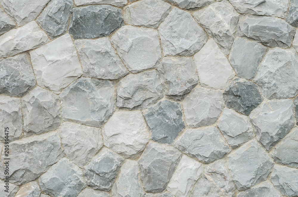 Closeup surface abstract at old stone wall in the garden textured background Closeup surface abstract at old stone wall in the garden textured background
