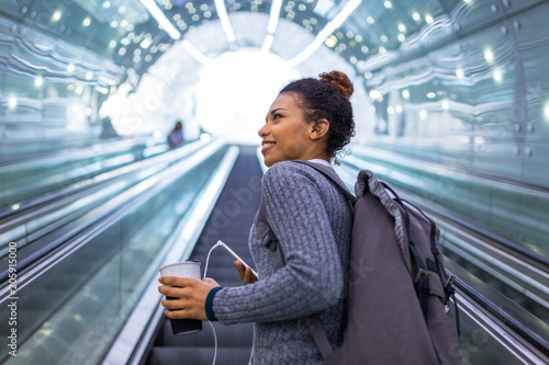 Young woman on subway escalator
