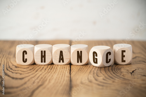 Cubes with letters where one of them has two letters showing the words "change" and "chance" at the same time 