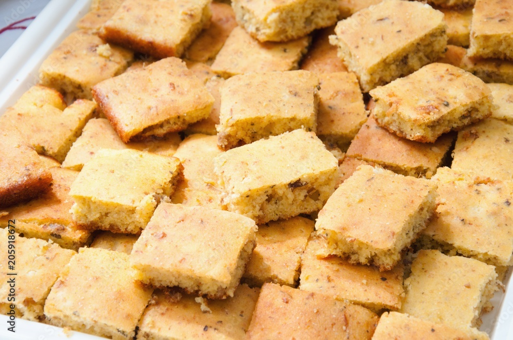 Stacked slices of homemade cornbread. freshly baked, cut into squares close up top view Stacked slices of homemade cornbread. freshly baked, cut into squares close up top view