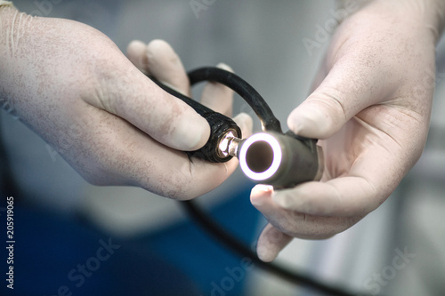 proctologist holding anoscope