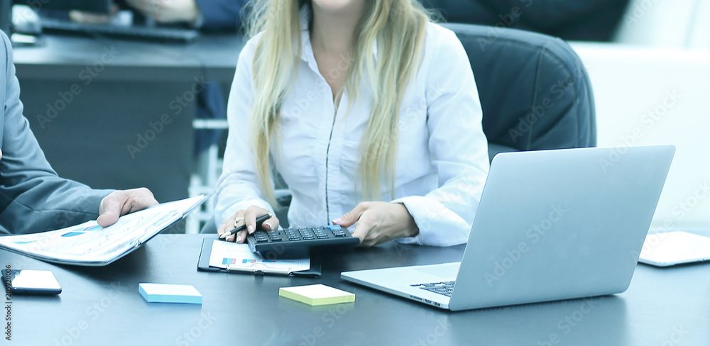 businessman and the assistant laughing while sitting at workplace in office. businessman and the assistant laughing while sitting at workplace in office.