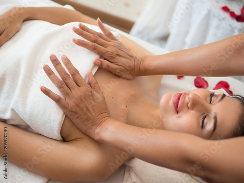 image of Beautiful young woman receiving massage in spa salon