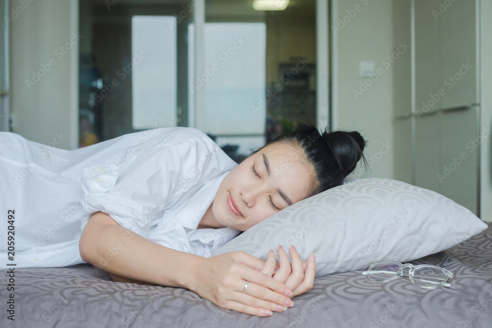 Portrait pretty young girl on bed in modern apartment in the morning Portrait pretty young girl on bed in modern apartment in the morning