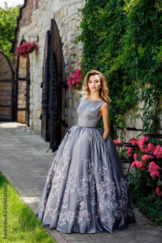 Fototapeta premium Beautiful girl with roses. Beauty model woman face. Perfect Skin