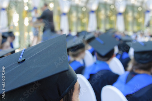 Students wearing gowns at school graduation cermoney photo