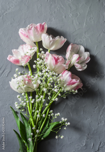 Garden bouquet of tulips on a gray background, top view. Copy space