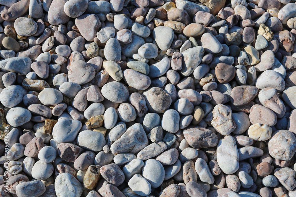 From above shot of smooth rocks lying on coast on sunny day. From above shot of smooth rocks lying on coast on sunny day.