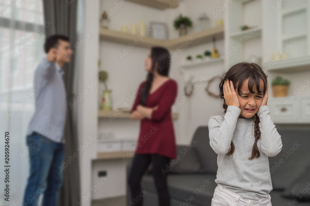 Little girl is crying because her parents quarrel. Little girl is crying because her parents quarrel.