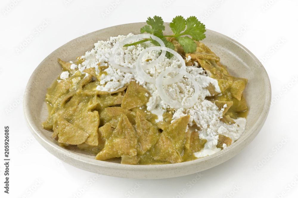 Mexican Chilaquiles, traditional dish made with tortillas served with green chili sauce Mexican Chilaquiles, traditional dish made with tortillas served with green chili sauce
