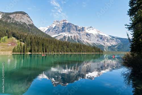 Fototapeta Naklejka Na Ścianę i Meble -  Canoe on Emerald Lake with Canadian Rocky Mountains reflection - Yoho NP, BC, Canada