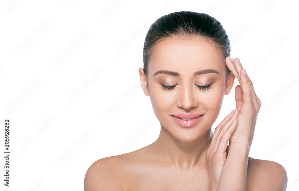 Young brunette woman smiling with closed eyes. She has natural make up on and freshness skin. Pure, all natural and fresh looking woman with perfect skin isolated on white Young brunette woman smiling with closed eyes. She has natural make up on and freshness skin. Pure, all natural and fresh looking woman with perfect skin isolated on white