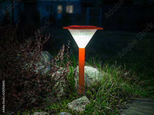 Decorative small red solar garden lantern. solar powered lamp