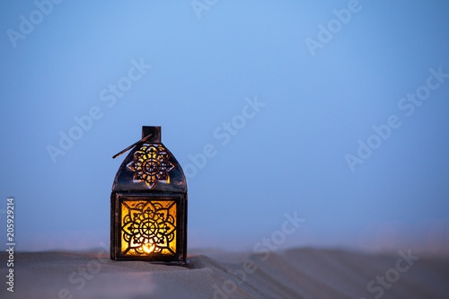 Traditional ornamental arabic lantern in desert. photo