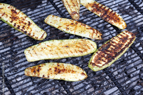 Close-up slices of zucchini fried on the grill