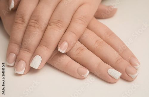 Light manicure in light on a white background.