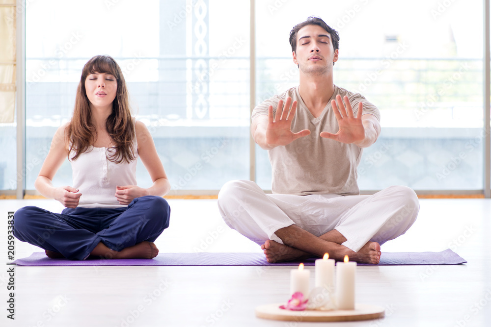 Personal coach helping during yoga session Personal coach helping during yoga session