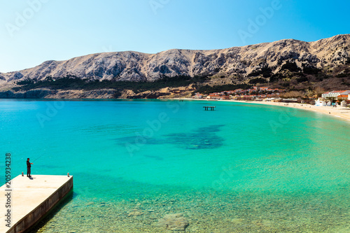 Baska and its beach in a sunny day, Krk Island, Dalmatia, Adriatic Coast, Croatia. photo
