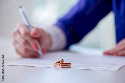 Woman signing prenuptial agreement in court photo