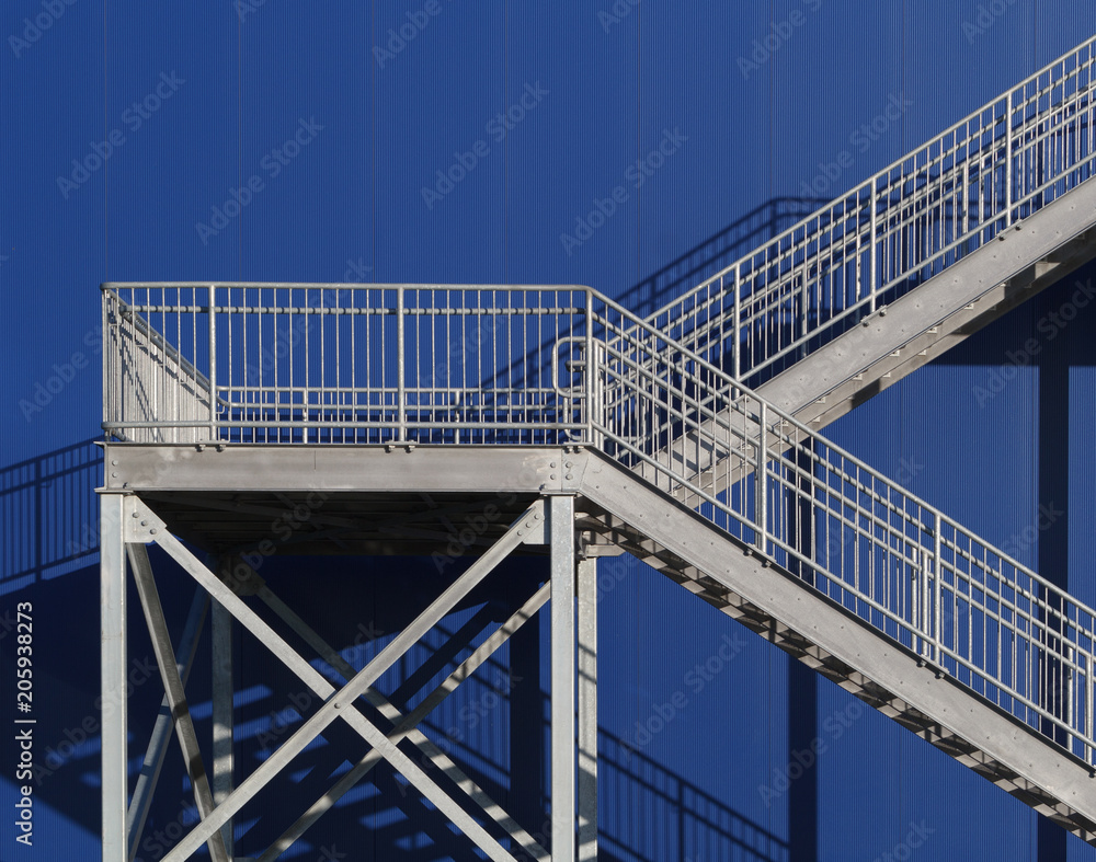 Fototapeta premium Steel stairwell detail on blue exterior wall