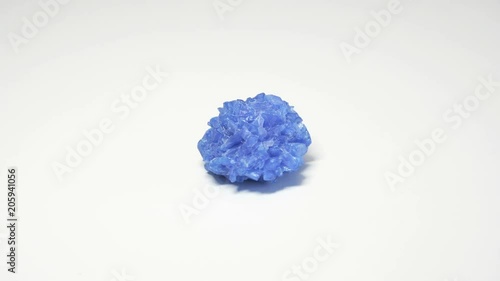 Macro shot of chalcanthite mineral isolated over white background and spinning around