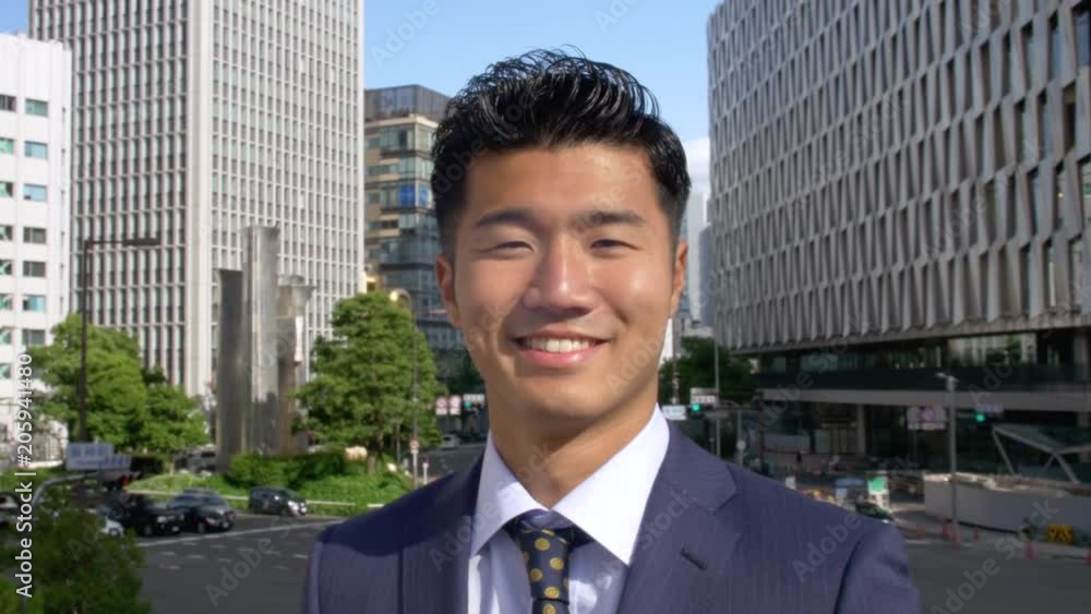 Japanese business man profile shot smiling. Japanese business man profile shot smiling.