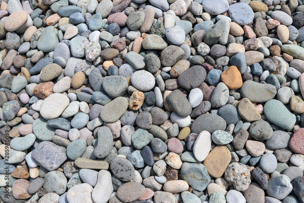 Smooth round pebbles textured background. Pebble sea beach close-up Smooth round pebbles textured background. Pebble sea beach close-up