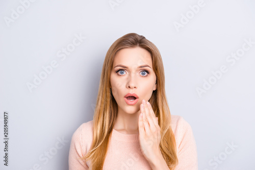 It's impossible! I don't believe you! People facial expressions grimacing big eyes concept. Close up portrait of attractive cute teenage girl holding palm near mouth isolated on gray background