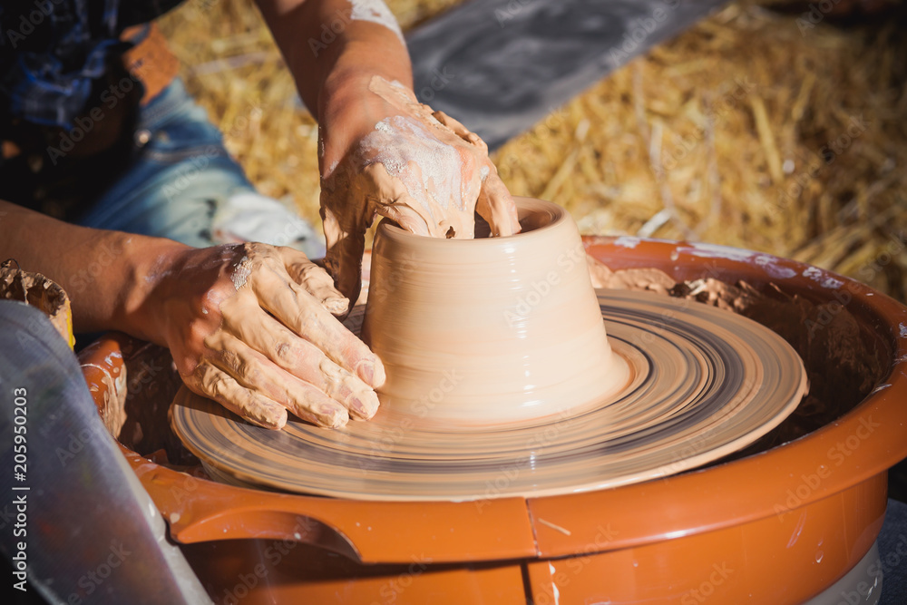 hands closeup, girl makes jug of clay on potter's wheel. hands closeup, girl makes jug of clay on potter's wheel.