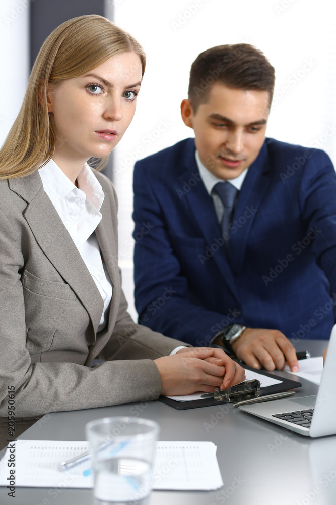 Business people using laptop pc while discussing project in office Business people using laptop pc while discussing project in office