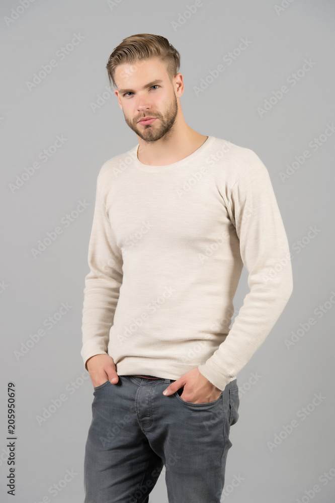 Man in casual tshirt and jeans. Macho with beard on unshaven face. Bearded man with hands in pockets. Confidence and charisma concept. Fashion style and trend Man in casual tshirt and jeans. Macho with beard on unshaven face. Bearded man with hands in pockets. Confidence and charisma concept. Fashion style and trend
