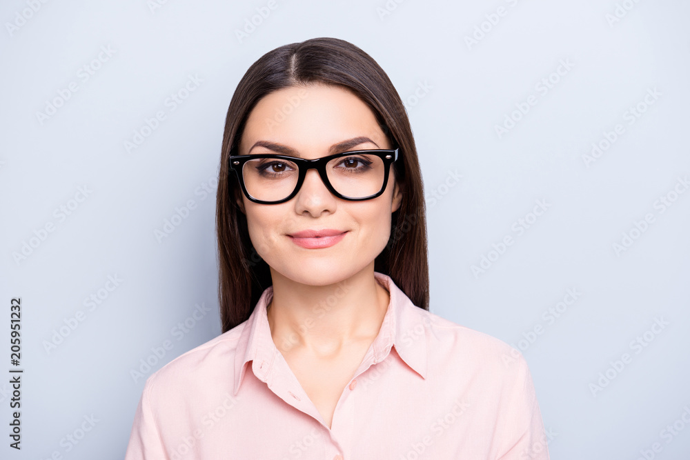 Portrait of clever charming brunette cute pretty woman in glasses, wearing classic shirt, looking at camera, isolated on grey background Portrait of clever charming brunette cute pretty woman in glasses, wearing classic shirt, looking at camera, isolated on grey background