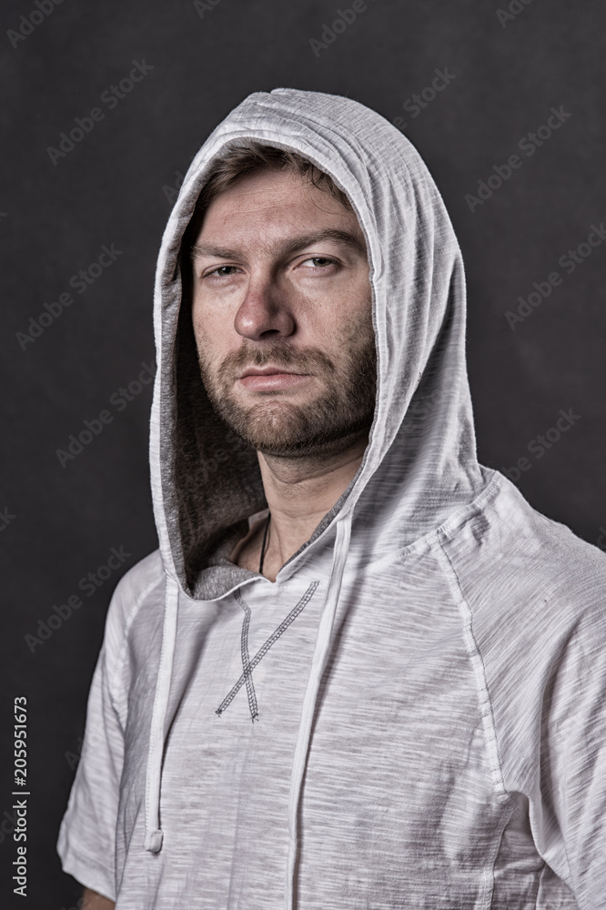 Man with beard wear hood. Barber salon and skincare concept. Bearded man in casual sweatshirt. Fashion model with unshaven face. Fashion style and trend, vintage filter Man with beard wear hood. Barber salon and skincare concept. Bearded man in casual sweatshirt. Fashion model with unshaven face. Fashion style and trend, vintage filter