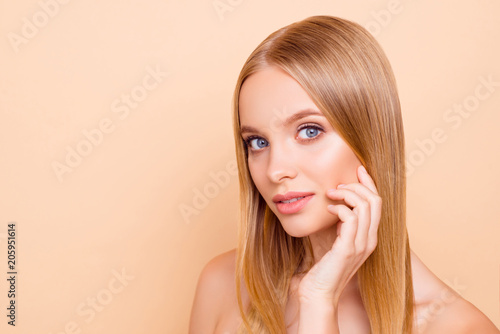 Portrait with copy space empty place of cute lovely charming gorgeous nude natural girl with flawless skin isolated on beige background, correction, moisturizing, hydration concept